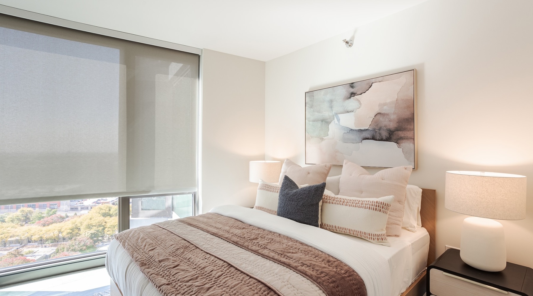 a bed with pillows and a lamp