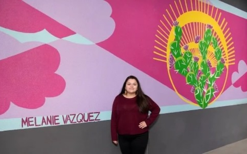 woman standing in front of mural