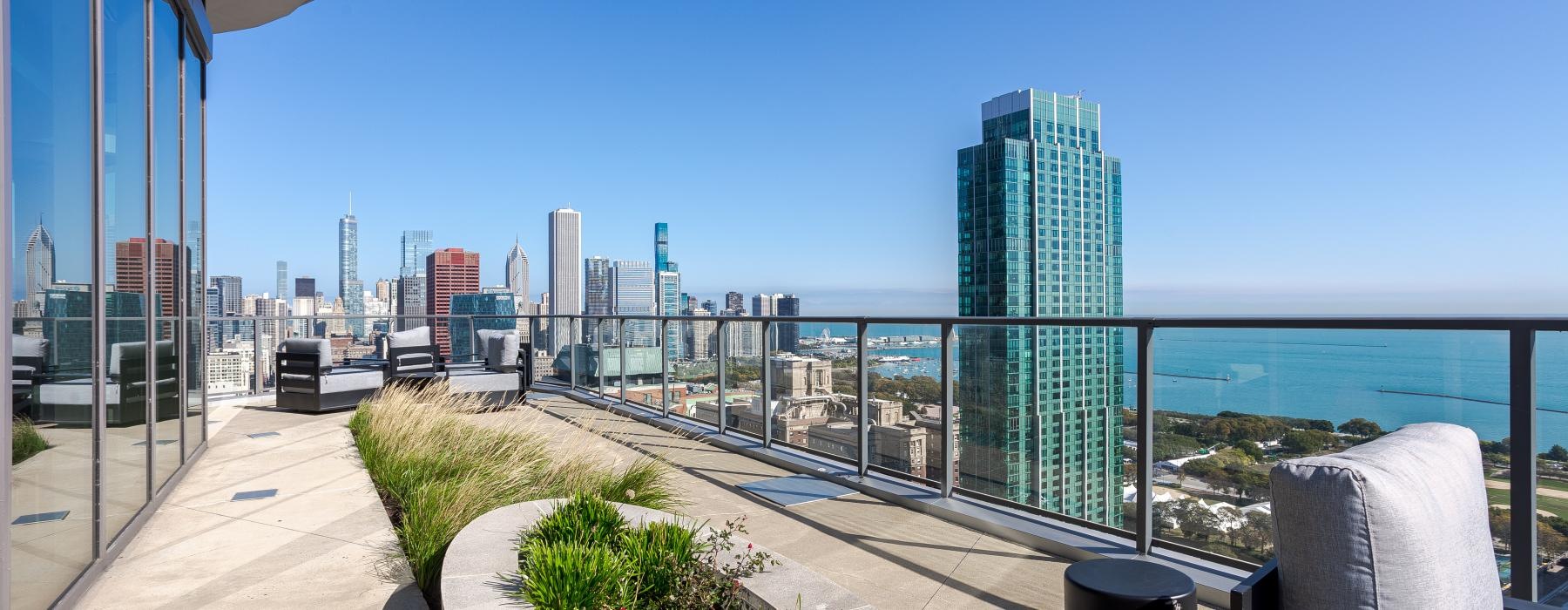 a walkway with a railing and a city skyline in the background